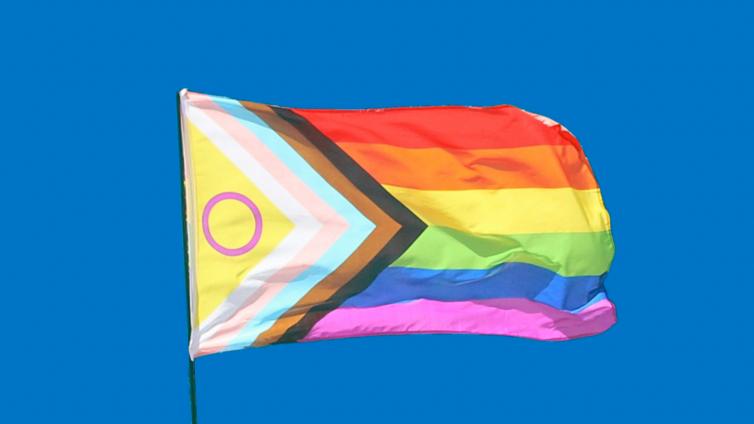 Pride flag against blue sky
